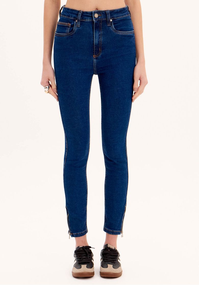 Vista frontal da calça jeans skinny ankle azul com detalhes de cintura alta.