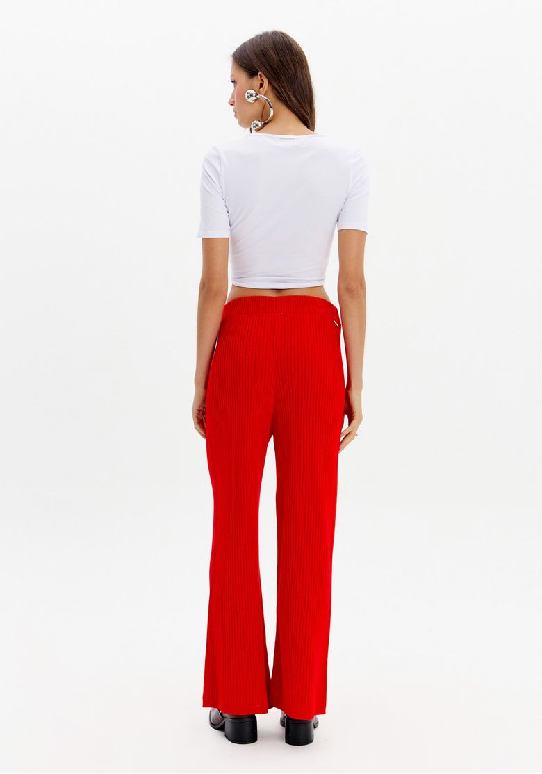 Vista traseira da calça wide leg de tricô vermelha, destacando o caimento amplo e confortável.