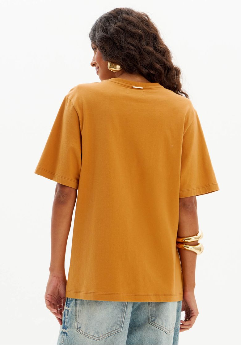 Vista traseira da t-shirt oversized marrom, mostrando o corte e o caimento.