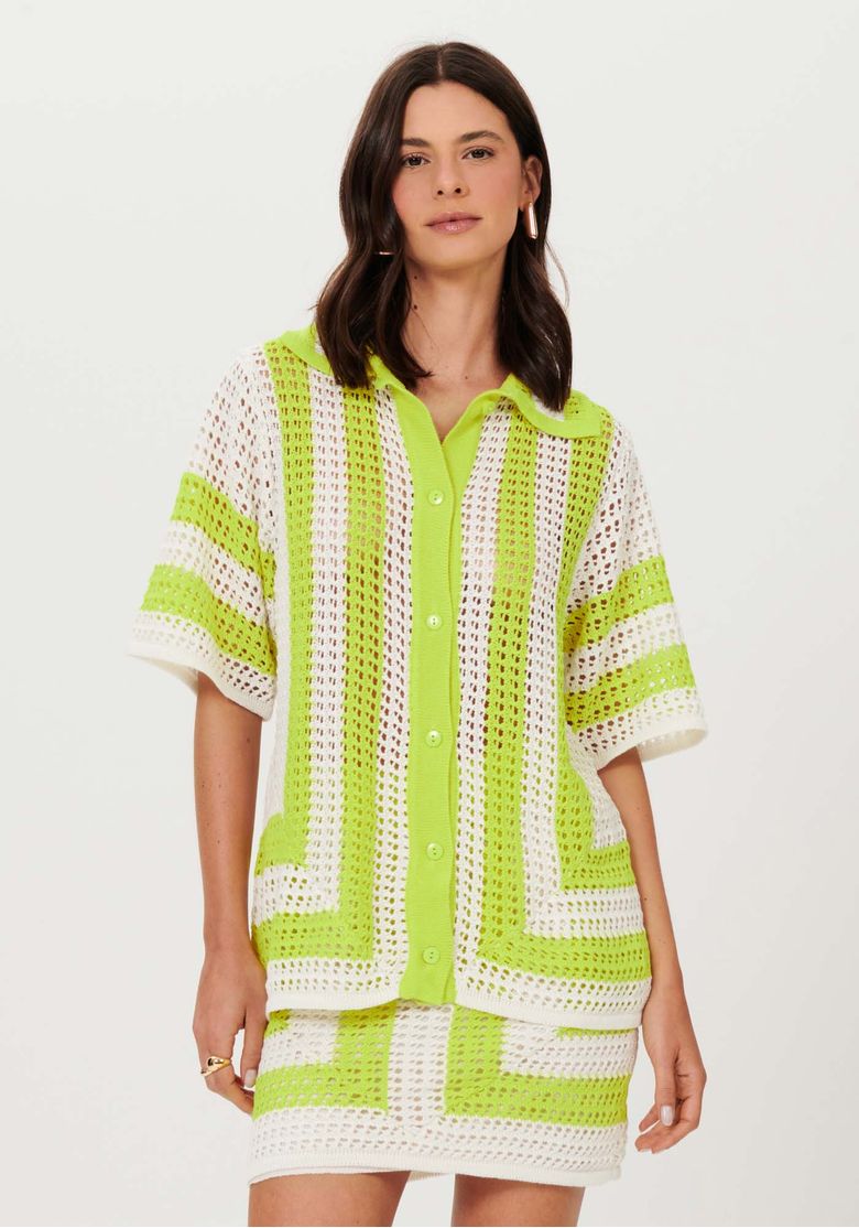 Camisa tricô oversized bege com padronagem geométrica vista frontal em modelo, malha aberta e abotoamento discreto
