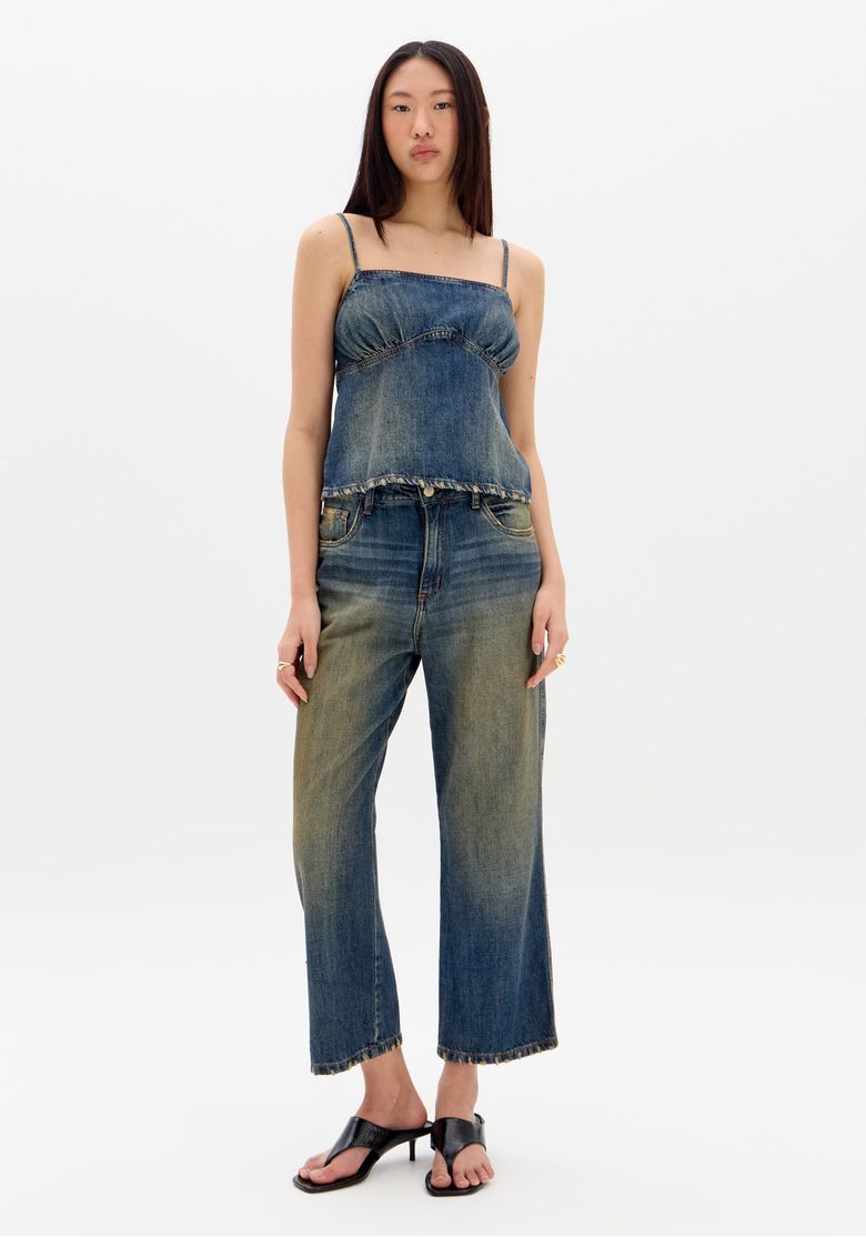 Vista completa da blusa jeans com lavagem escura, modelo de costas.