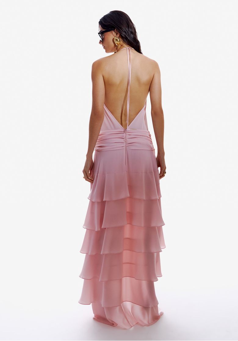 Verso completo do vestido mullet exibindo babados em camadas em cascata, tecido leve rosa claro