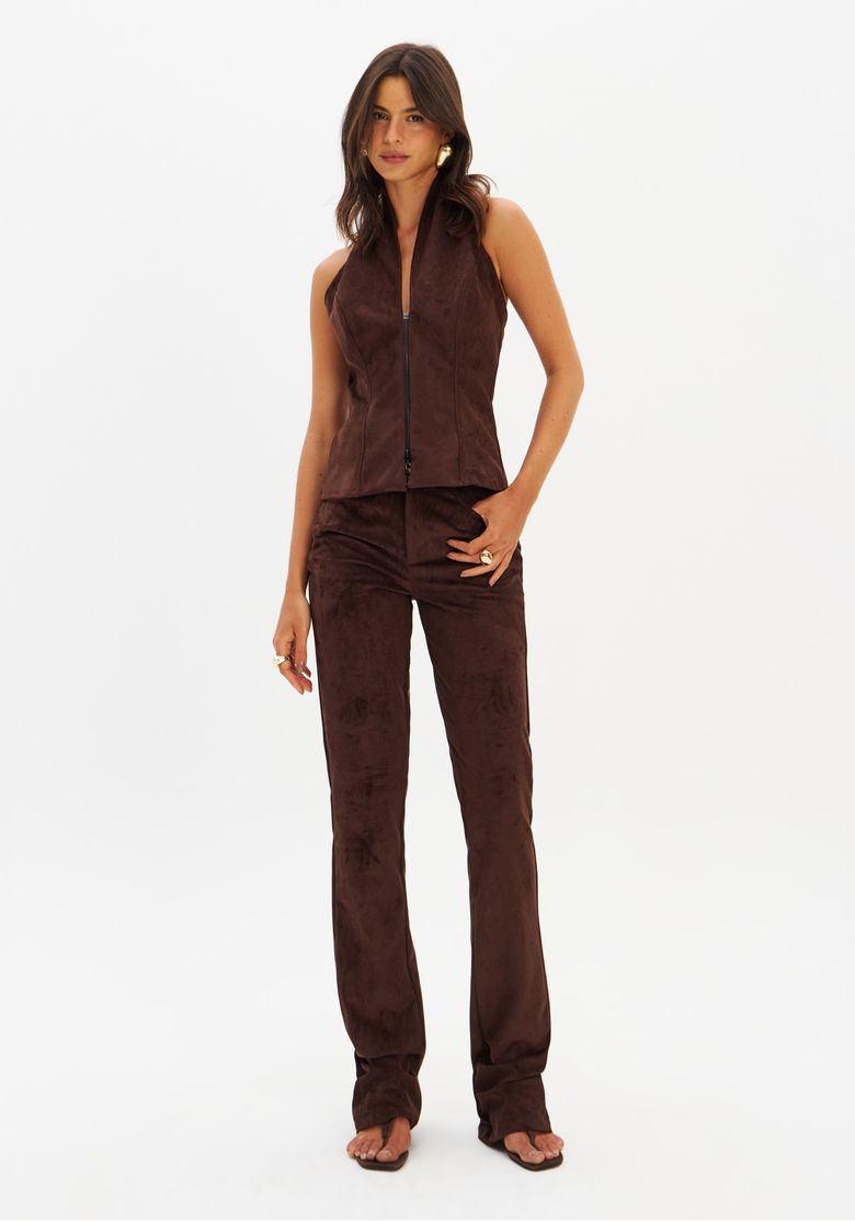 Modelo vestindo calça skinny em suede marrom com top combinando, vista frontal.