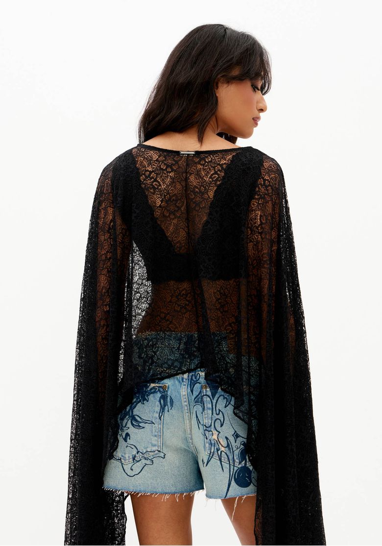 Close-costas-de-blusa-capa-feminina-de-renda-preta-com-transparencia-caimento-fluido-e-comprimento-alongado-nas-mangas