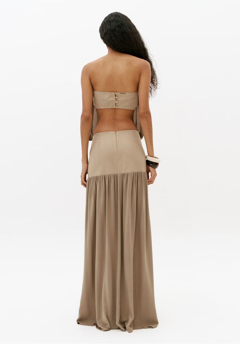 Vista traseira completa de vestido longo bege com saia longa fluida e recorte franzido